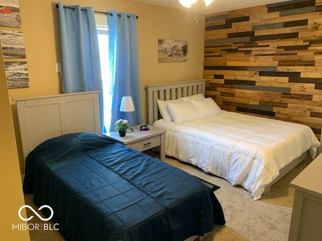 carpeted bedroom with wood walls