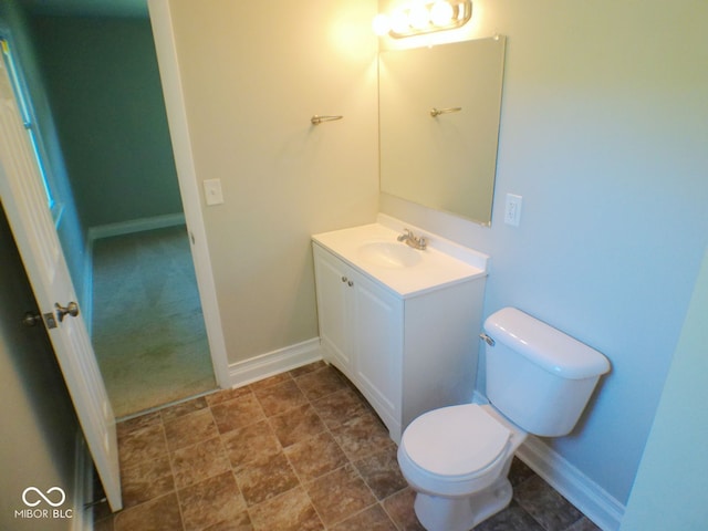 bathroom featuring toilet and vanity