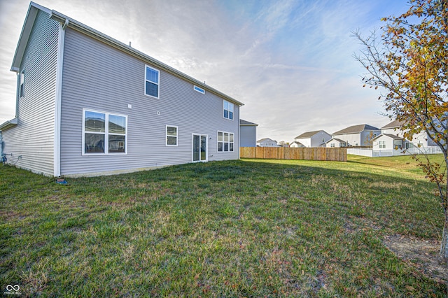 rear view of property featuring a yard