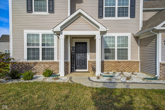 doorway to property featuring a yard