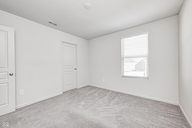 unfurnished room with light colored carpet