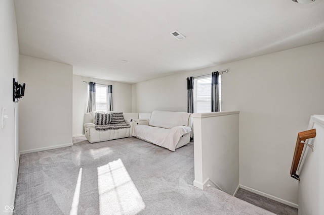 unfurnished living room with light colored carpet