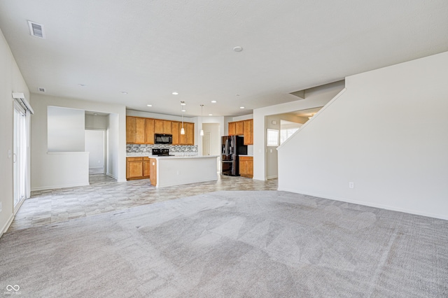 unfurnished living room featuring light colored carpet