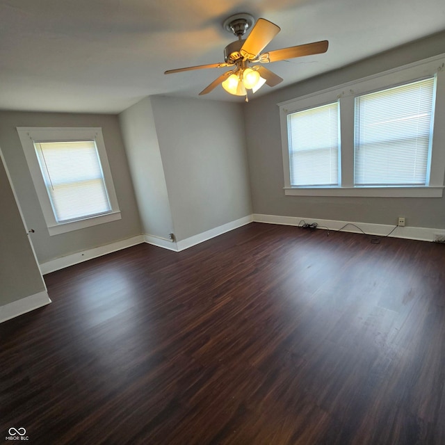 unfurnished room featuring dark hardwood / wood-style flooring, ceiling fan, and a wealth of natural light