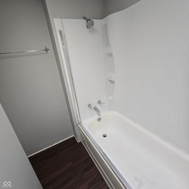 709 W Riverside Ave, Muncie, IN 47303 - bathroom featuring wood finished floors, tub / shower combination, and baseboards