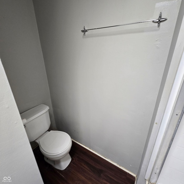 bathroom featuring wood-type flooring and toilet