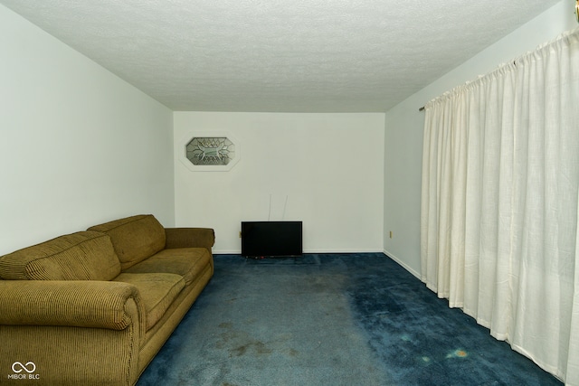 living room with a textured ceiling and dark colored carpet