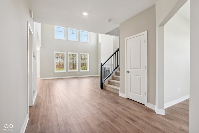 entryway with a high ceiling and light hardwood / wood-style floors