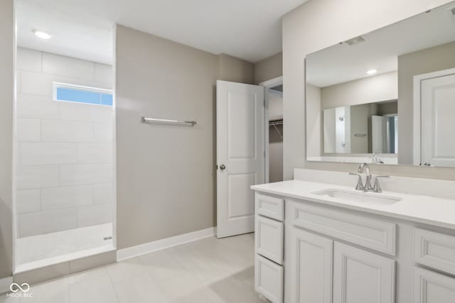 bathroom with a shower and vanity