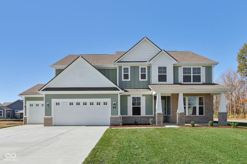 craftsman-style house featuring a porch, a garage, and a front lawn