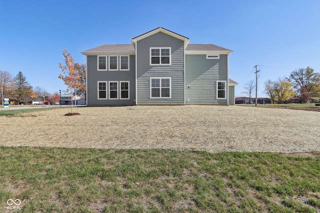 rear view of property with a lawn