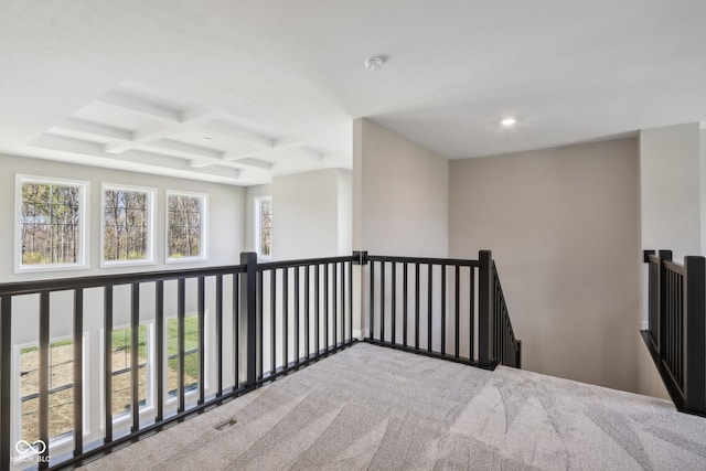 interior space featuring beamed ceiling, carpet, and coffered ceiling