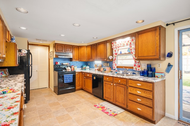 kitchen with black appliances, sink, and a wealth of natural light