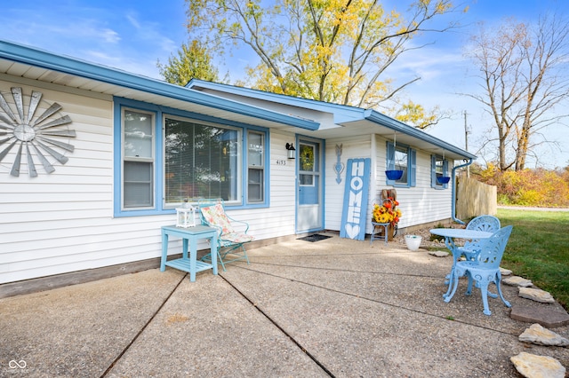 view of exterior entry with a patio