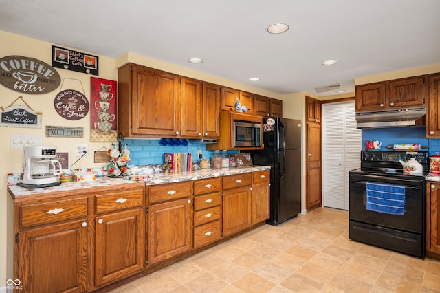 kitchen with black appliances and backsplash