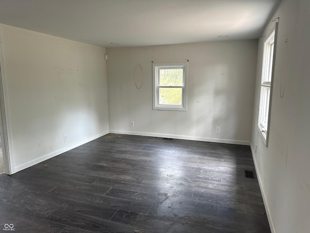 unfurnished room with dark hardwood / wood-style floors