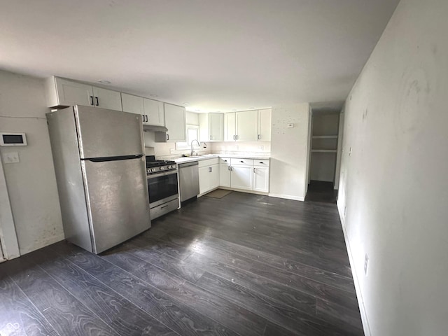 kitchen with white cabinetry, stainless steel appliances, sink, and dark hardwood / wood-style floors