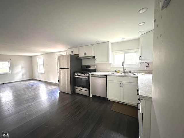 kitchen featuring appliances with stainless steel finishes, white cabinets, sink, and a wealth of natural light