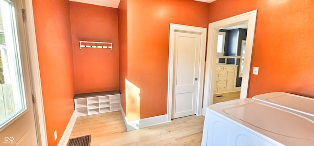 laundry room featuring light hardwood / wood-style flooring and washing machine and clothes dryer