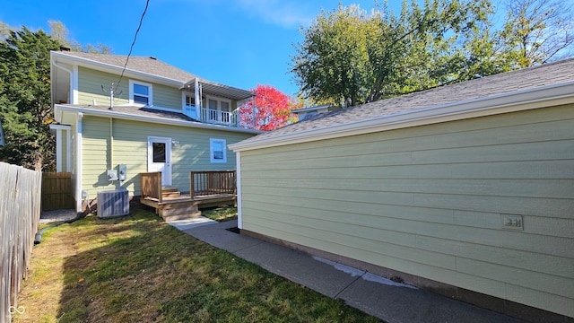 back of property featuring a yard, cooling unit, and a wooden deck