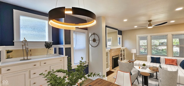 interior space featuring ceiling fan, light hardwood / wood-style floors, and a wealth of natural light