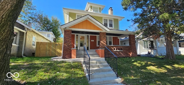 view of front facade with covered porch and a front lawn