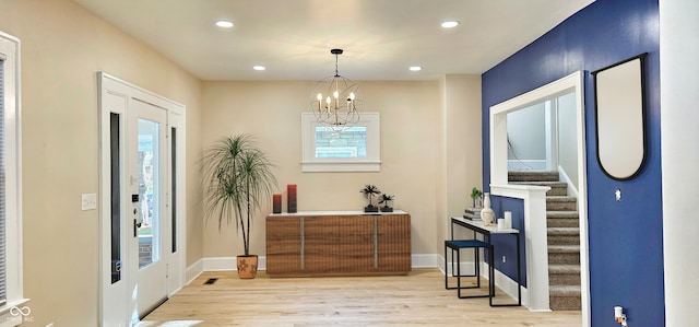 entryway featuring a chandelier and light wood-type flooring