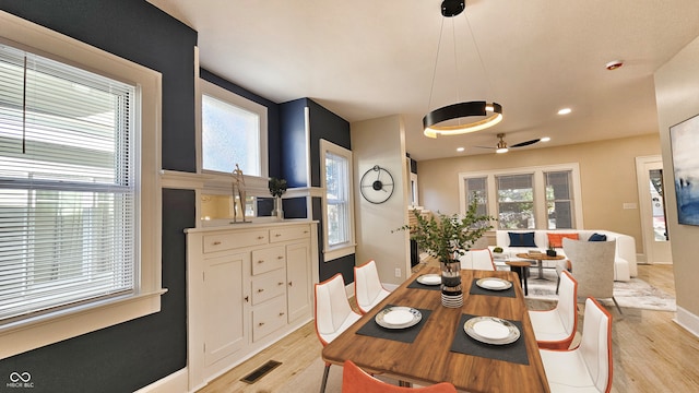 dining space featuring ceiling fan, light hardwood / wood-style flooring, and a healthy amount of sunlight