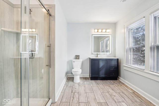 bathroom with vanity, toilet, and walk in shower