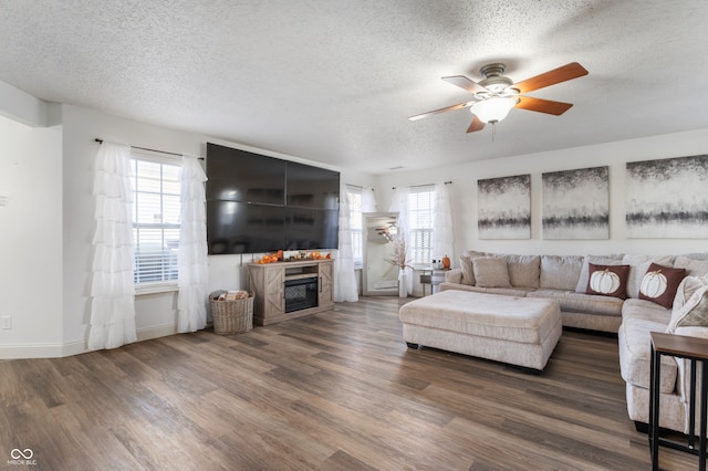 living room featuring dark hardwood / wood-style flooring, a healthy amount of sunlight, and a textured ceiling