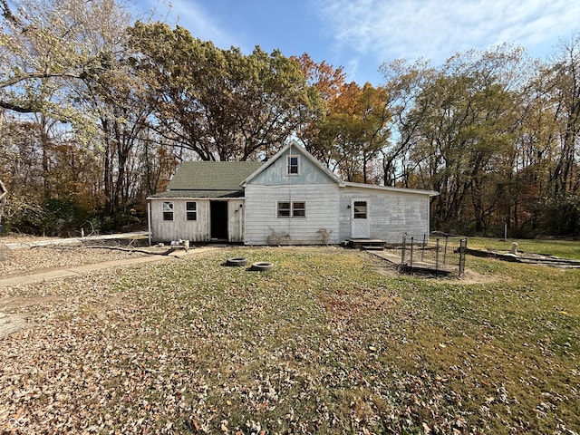 back of property with a yard