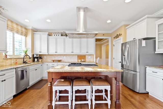 kitchen featuring appliances with stainless steel finishes, a center island, and light hardwood / wood-style flooring