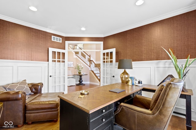 office featuring french doors, ornamental molding, and hardwood / wood-style flooring