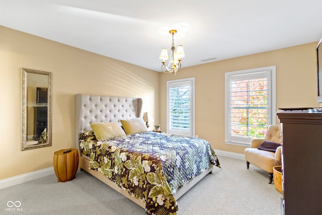 bedroom with carpet flooring and an inviting chandelier