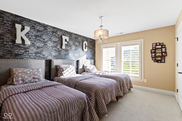 carpeted bedroom with a notable chandelier