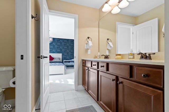 bathroom featuring tile patterned floors, vanity, and toilet