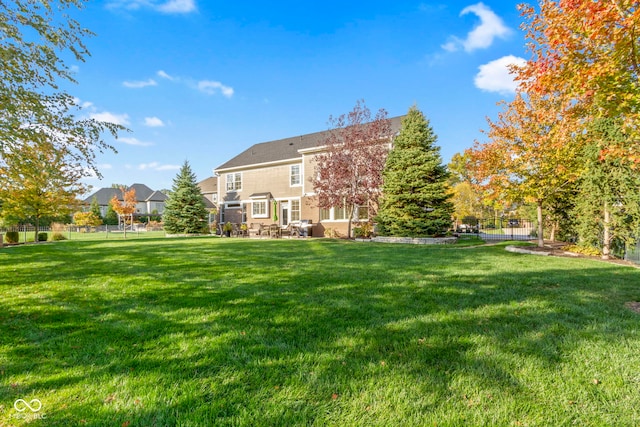 rear view of house with a yard