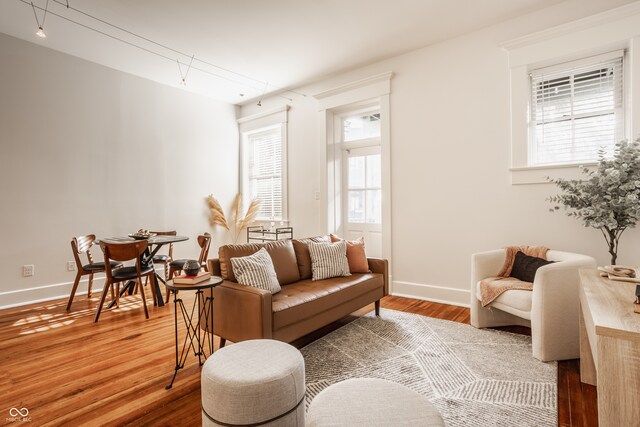 sitting room featuring hardwood / wood-style floors and a healthy amount of sunlight