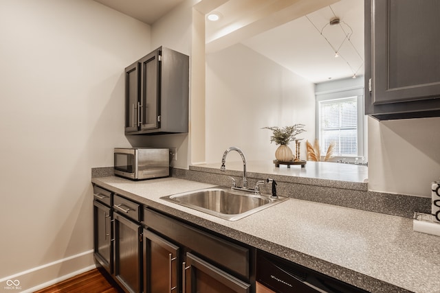 kitchen featuring sink and dark hardwood / wood-style flooring