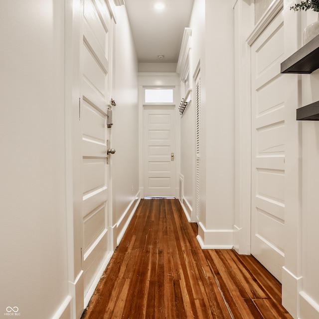 corridor with dark hardwood / wood-style floors