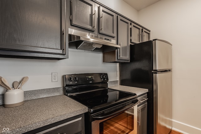 kitchen with black electric range and stainless steel refrigerator