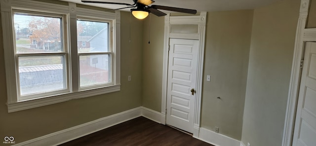 unfurnished bedroom with dark wood-type flooring and ceiling fan