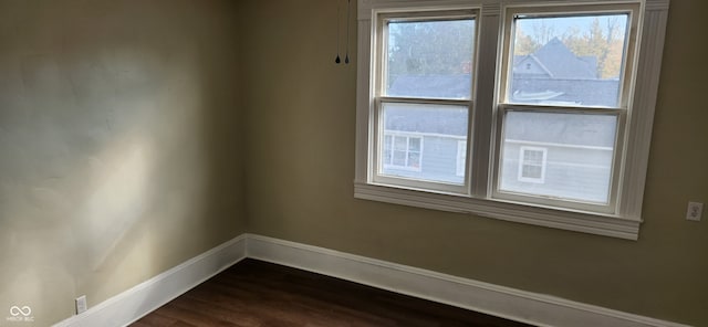 spare room with dark hardwood / wood-style floors