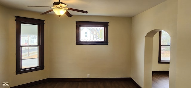 empty room with dark hardwood / wood-style floors and ceiling fan