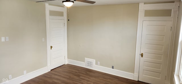 spare room with ceiling fan and dark hardwood / wood-style flooring