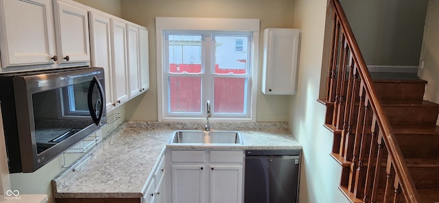 kitchen featuring sink, appliances with stainless steel finishes, and white cabinets