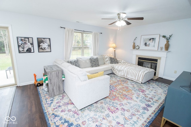 living room featuring dark hardwood / wood-style flooring and ceiling fan