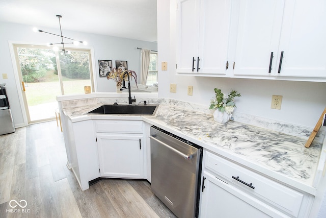 kitchen with dishwasher, a wealth of natural light, sink, and white cabinets