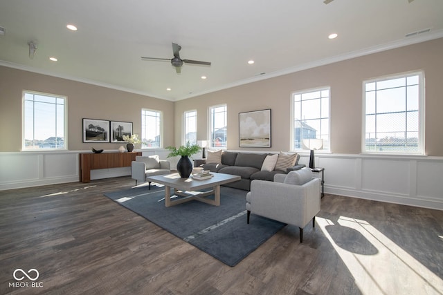 living room with dark wood-type flooring, ornamental molding, and ceiling fan