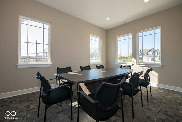 dining room with dark colored carpet